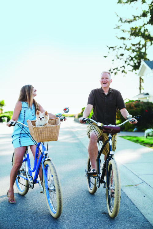 A couple of Sea Meadow residents take a bike ride at one of the streets of the community
